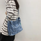 Elevate your casual look with this denim shoulder bag for women. Featuring a large design and zipper closure, this bag is perfect for shopping and everyday use, adding a touch of style to your outfit. -