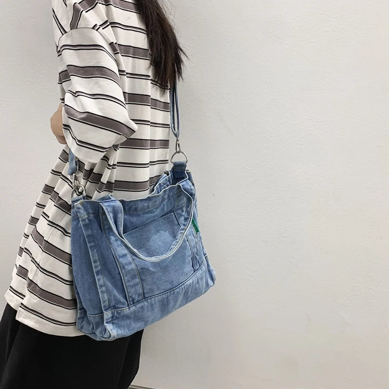 Elevate your casual look with this denim shoulder bag for women. Featuring a large design and zipper closure, this bag is perfect for shopping and everyday use, adding a touch of style to your outfit. -