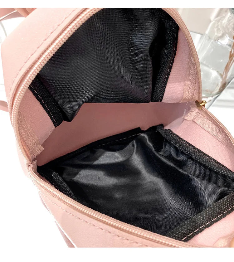 Carry your essentials in style with this fashionable women's bag. Featuring double pockets and embroidered details, this small book bag is perfect for adding a trendy touch to your outfit. -