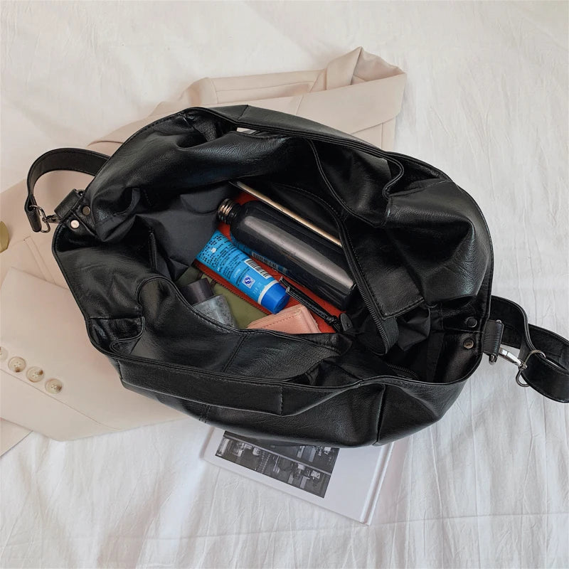 Make a stylish statement with these large shoulder bags designed for women. Crafted from soft leather, these fashionable handbags are perfect for adding a touch of sophistication to any outfit. -