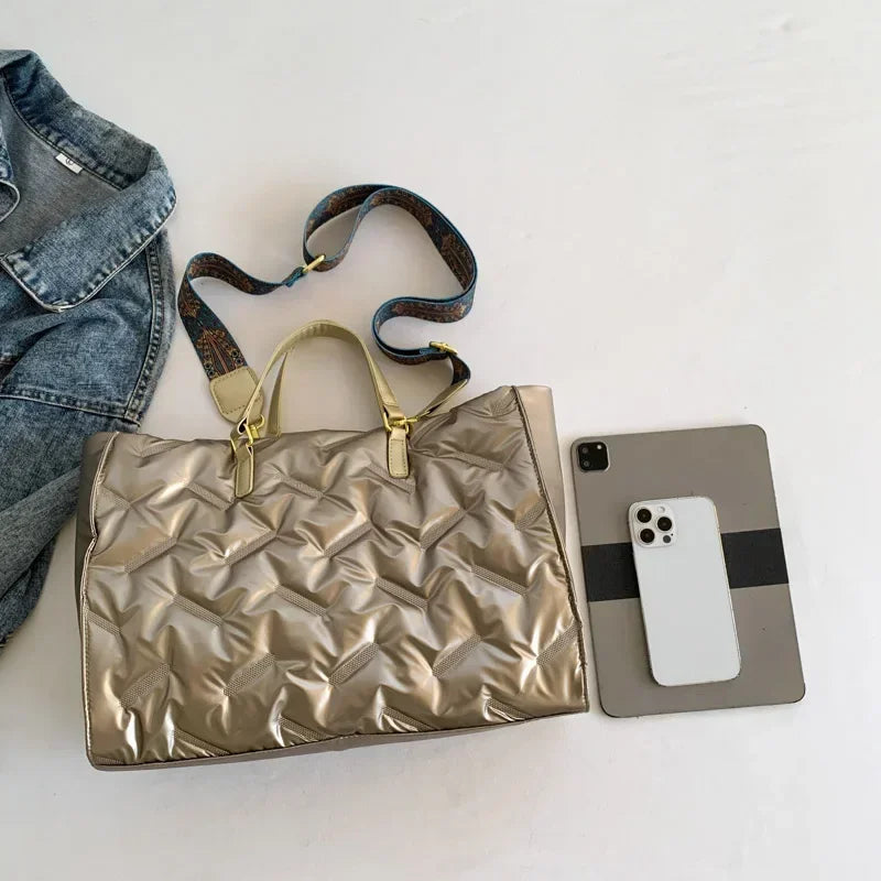 Stay on-trend with this fashion-forward large tote padded handbag featuring a designer quilted design. This stylish accessory is perfect for adding a touch of sophistication and elegance to your ensemble. -