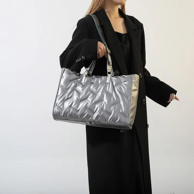 Stay on-trend with this fashion-forward large tote padded handbag featuring a designer quilted design. This stylish accessory is perfect for adding a touch of sophistication and elegance to your ensemble. -