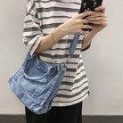 Elevate your casual look with this denim shoulder bag for women. Featuring a large design and zipper closure, this bag is perfect for shopping and everyday use, adding a touch of style to your outfit. -