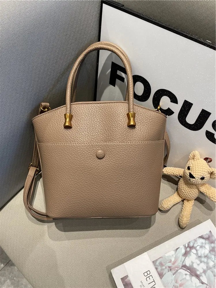 Elevate your style with this elegant tote bag. Crafted from genuine leather, this bag exudes sophistication and is the perfect accessory for a chic and classy look. -