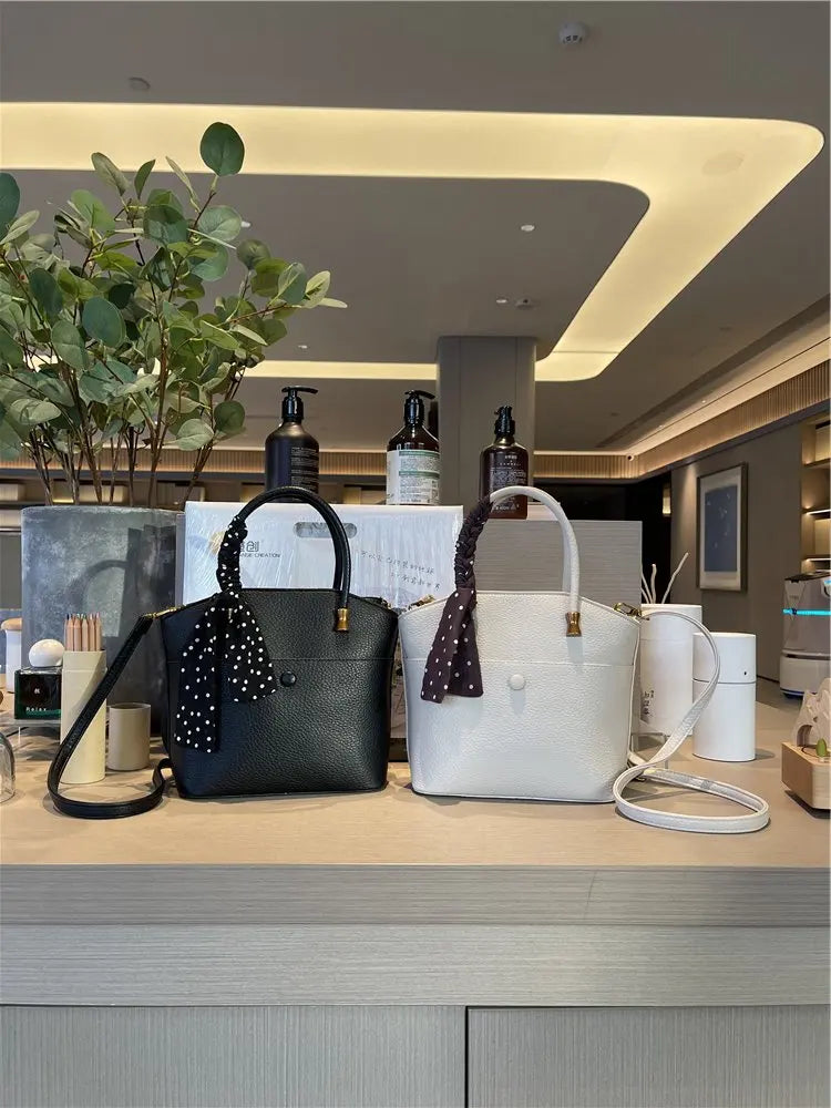 Elevate your style with this elegant tote bag. Crafted from genuine leather, this bag exudes sophistication and is the perfect accessory for a chic and classy look. -
