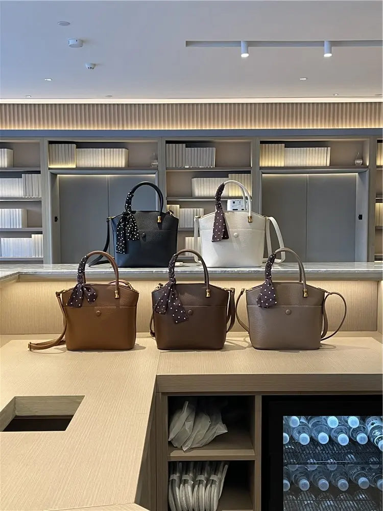 Elevate your style with this elegant tote bag. Crafted from genuine leather, this bag exudes sophistication and is the perfect accessory for a chic and classy look. -