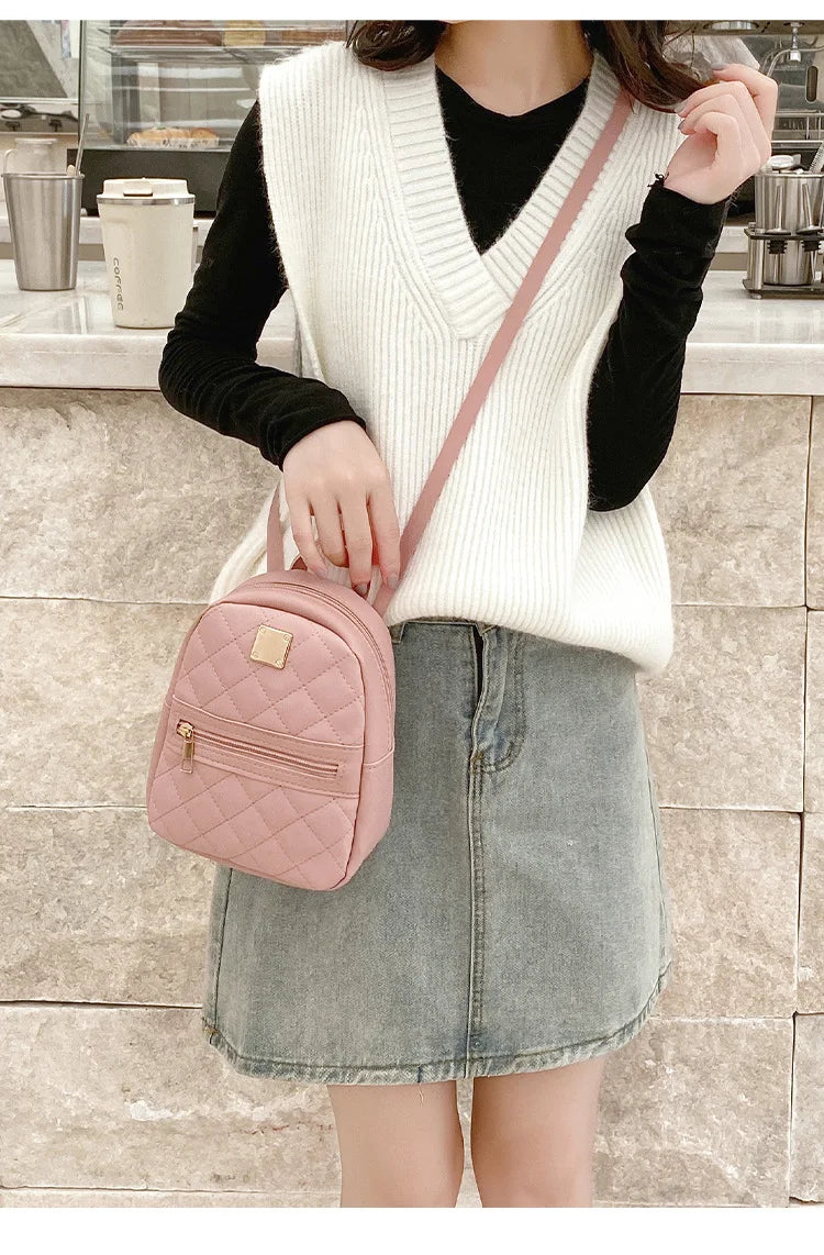 Carry your essentials in style with this fashionable women's bag. Featuring double pockets and embroidered details, this small book bag is perfect for adding a trendy touch to your outfit. -