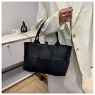 Make a fashion statement with this large capacity handbag. Crafted with stylish woven leather, this tote bag is perfect for adding a touch of elegance to your everyday outfit. -