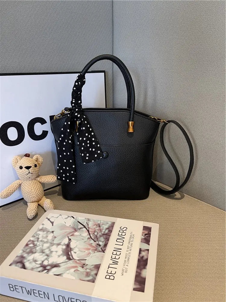 Elevate your style with this elegant tote bag. Crafted from genuine leather, this bag exudes sophistication and is the perfect accessory for a chic and classy look. -