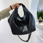 Make a stylish statement with these large shoulder bags designed for women. Crafted from soft leather, these fashionable handbags are perfect for adding a touch of sophistication to any outfit. -