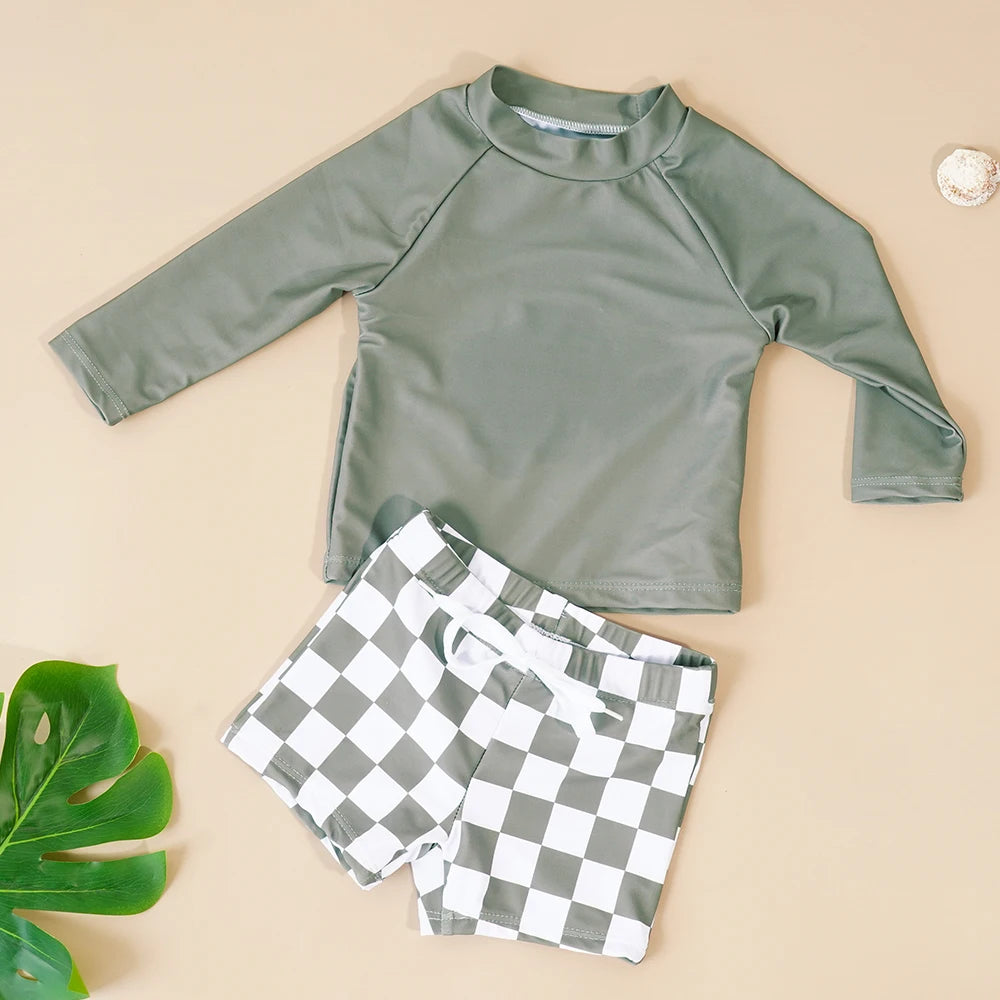 Make a splash in style with this fashionable and cute long-sleeve swimsuit for baby boys and girls—perfect for pool days and swim fun! -