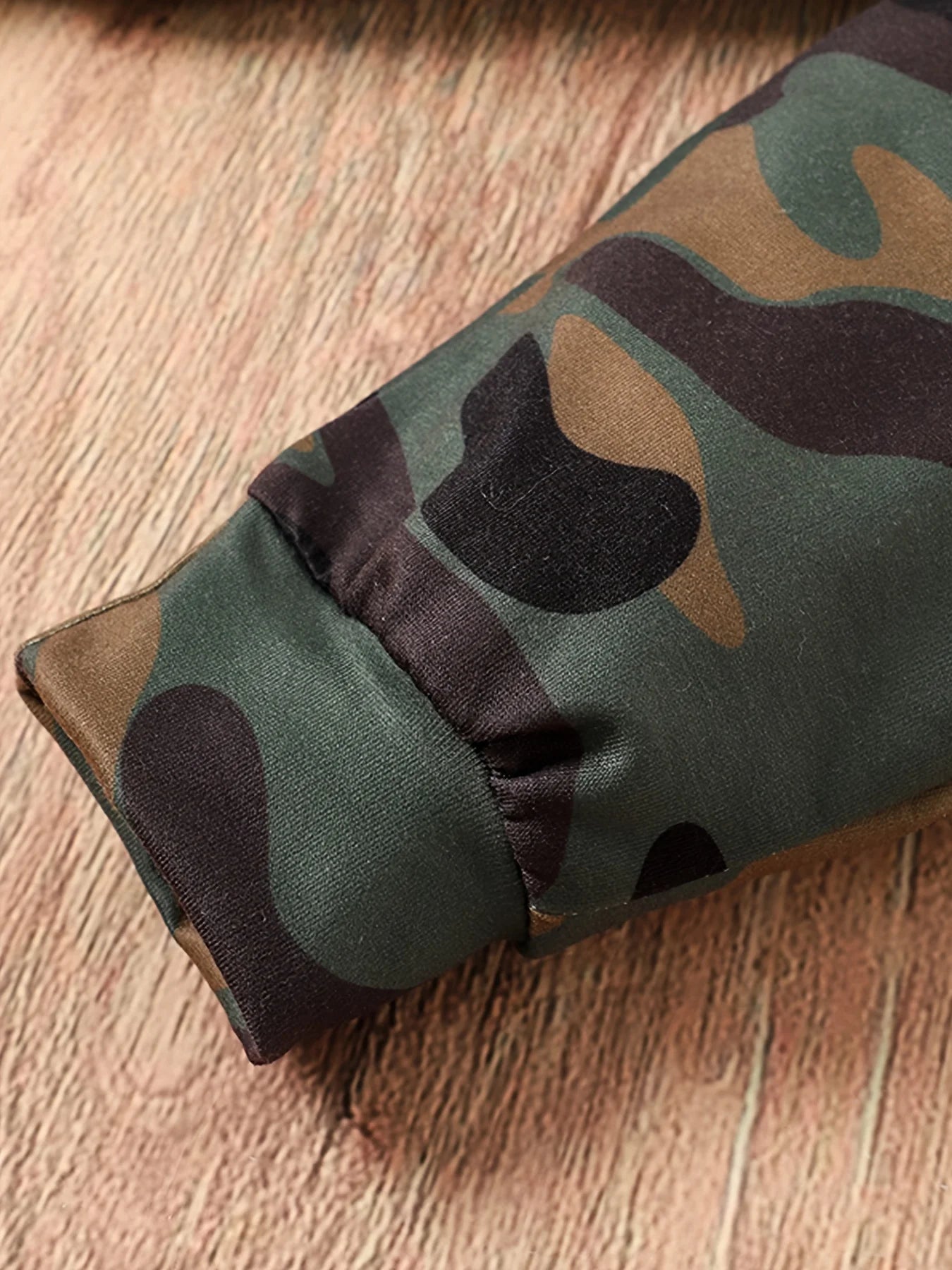 Dress your little guy sharp and comfy with this two-piece baby boy set—long-sleeved round neck top paired with stylish camouflage pants! -
