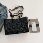 Stay on-trend with this fashion-forward large tote padded handbag featuring a designer quilted design. This stylish accessory is perfect for adding a touch of sophistication and elegance to your ensemble. -