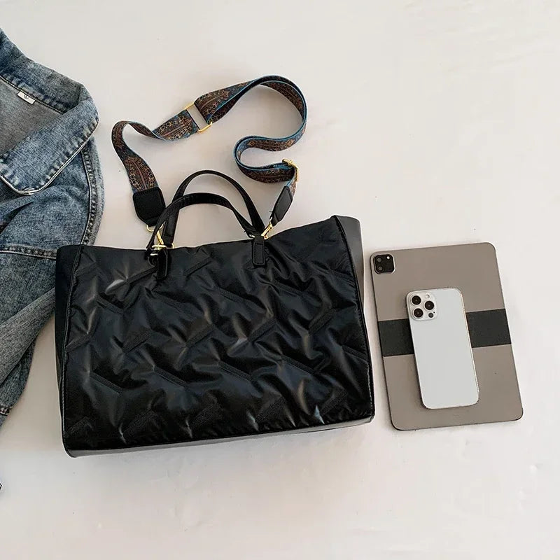 Stay on-trend with this fashion-forward large tote padded handbag featuring a designer quilted design. This stylish accessory is perfect for adding a touch of sophistication and elegance to your ensemble. -