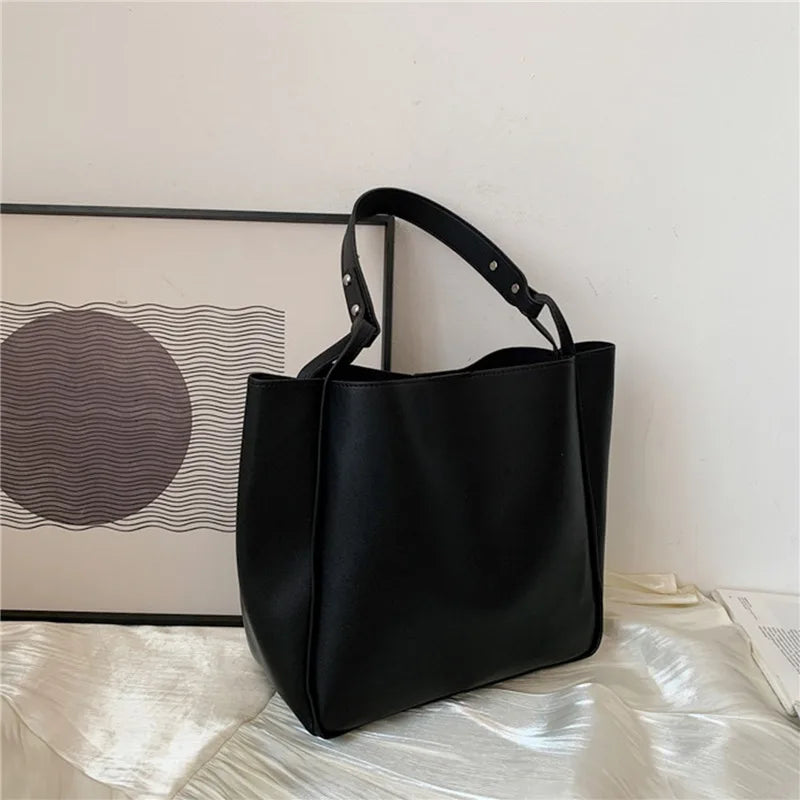 Elevate your style with these retro-inspired bucket shoulder bag made of real leather. -