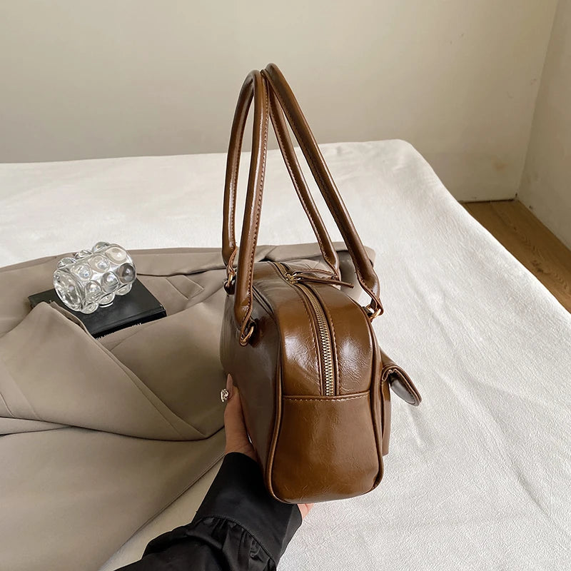 Accessorize stylishly with this black shoulder bag for women. This versatile handbag can be carried as a purse or a crossbody bag, making it a chic and practical choice for all occasions. -