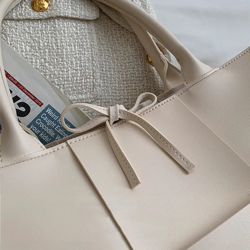 Make a fashion statement with this large capacity handbag. Crafted with stylish woven leather, this tote bag is perfect for adding a touch of elegance to your everyday outfit. -