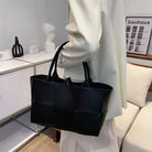 Make a fashion statement with this large capacity handbag. Crafted with stylish woven leather, this tote bag is perfect for adding a touch of elegance to your everyday outfit. -