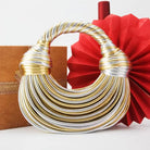 Make a statement with this gold luxury designer brand handwoven noodle bag. With a rope-knotted hobo design and a chic silver evening clutch, this bag is the epitome of high fashion and sophistication. -