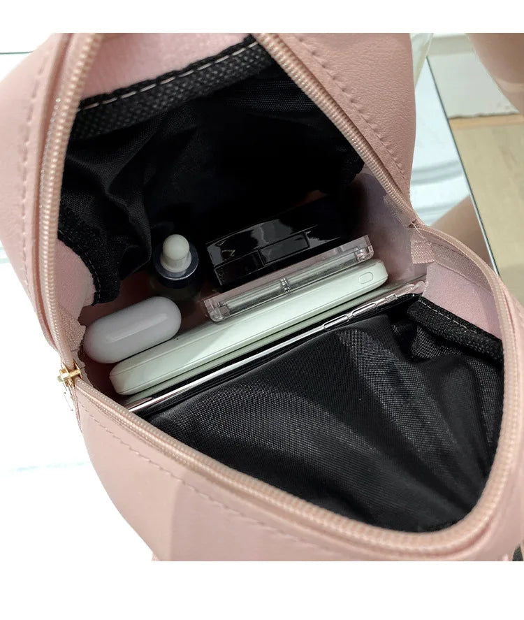 Carry your essentials in style with this fashionable women's bag. Featuring double pockets and embroidered details, this small book bag is perfect for adding a trendy touch to your outfit. -