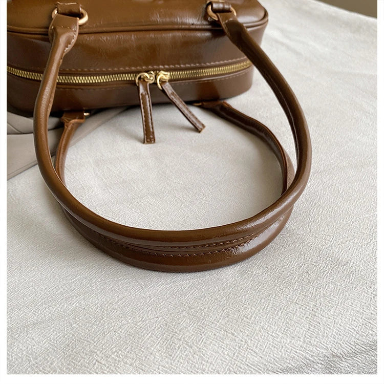 Accessorize stylishly with this black shoulder bag for women. This versatile handbag can be carried as a purse or a crossbody bag, making it a chic and practical choice for all occasions. -
