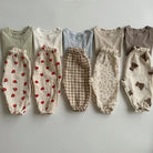 Keep your little ones comfy and cute in these organic cotton loose-fit baby pants—featuring playful tiger, bear, and floral prints perfect for boys and girls! -