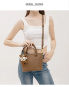 Upgrade your accessories with this new bucket bag for women. Featuring a fashionable and versatile design, this handheld bag is perfect for adding a chic and trendy touch to your look. -