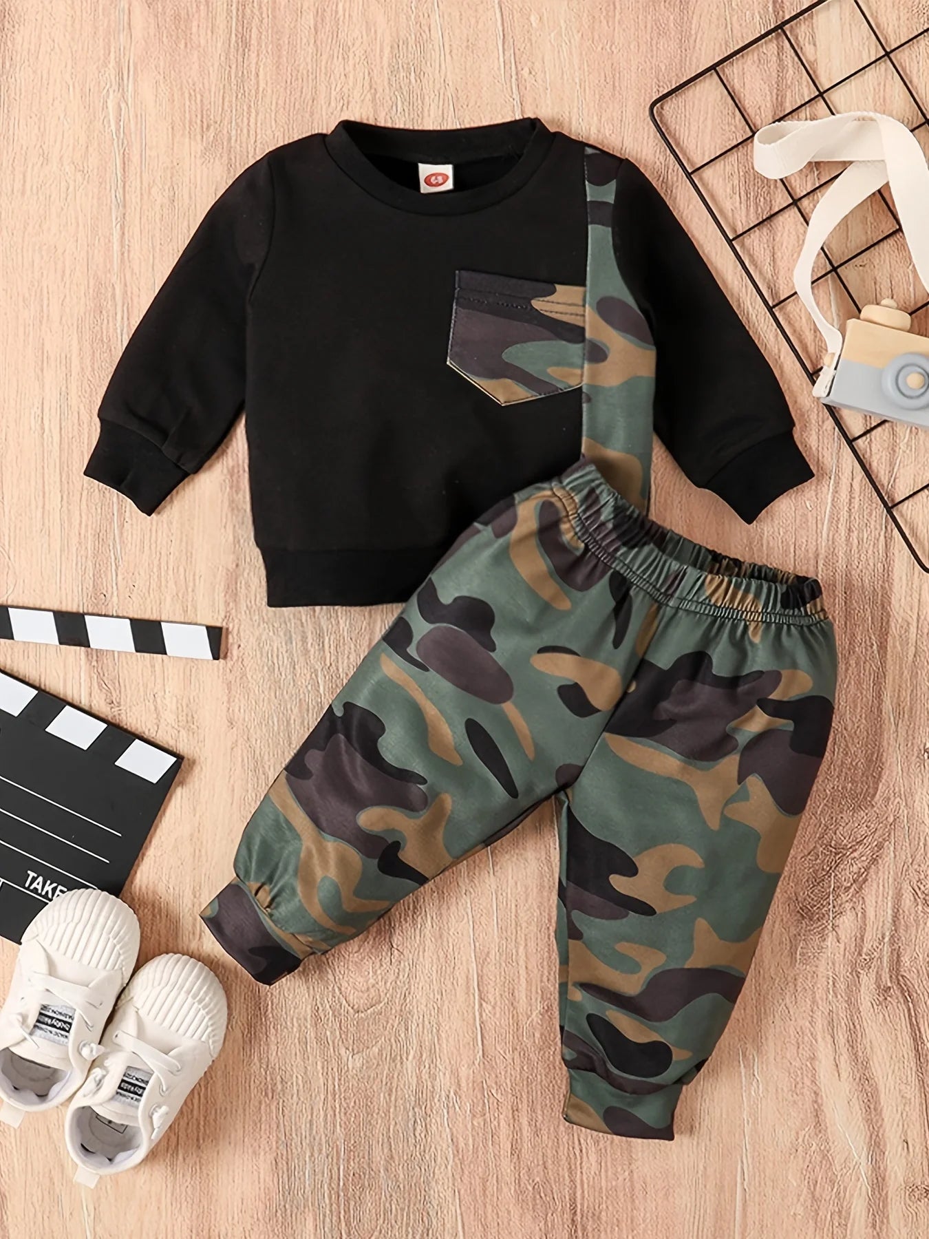 Dress your little guy sharp and comfy with this two-piece baby boy set—long-sleeved round neck top paired with stylish camouflage pants! -