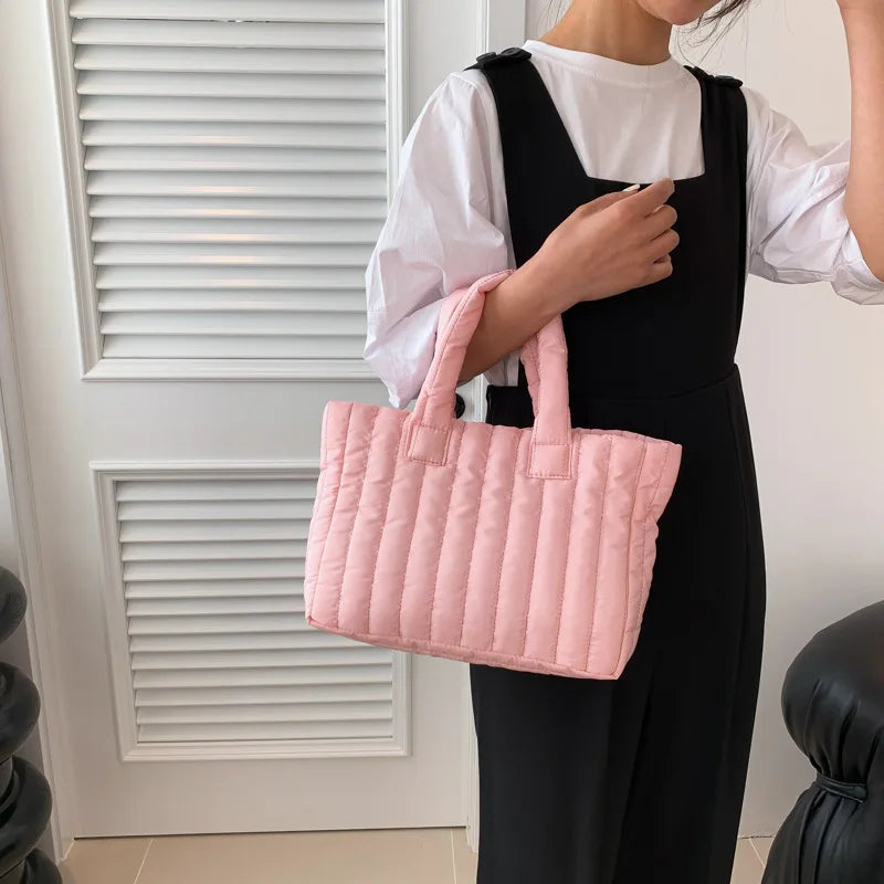 Carry your essentials in style with this large capacity and cotton-padded tote bag designed for ladies. Featuring a solid color and casual fashion, this bag is both practical and fashionable for everyday use. -