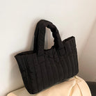 Carry your essentials in style with this large capacity and cotton-padded tote bag designed for ladies. Featuring a solid color and casual fashion, this bag is both practical and fashionable for everyday use. -