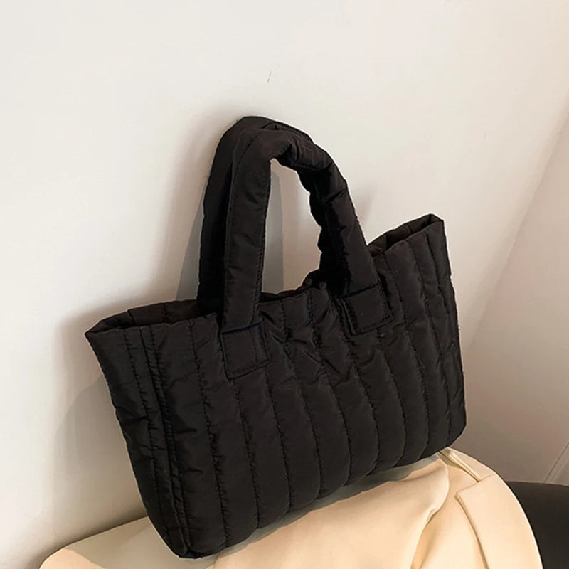 Carry your essentials in style with this large capacity and cotton-padded tote bag designed for ladies. Featuring a solid color and casual fashion, this bag is both practical and fashionable for everyday use. -