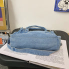 Elevate your casual look with this denim shoulder bag for women. Featuring a large design and zipper closure, this bag is perfect for shopping and everyday use, adding a touch of style to your outfit. -