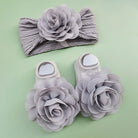 Complete your baby girl's outfit with this sweet 2-piece set—featuring delicate pearl, lace, and flower headbands along with matching socks! -