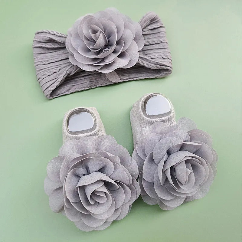 Complete your baby girl's outfit with this sweet 2-piece set—featuring delicate pearl, lace, and flower headbands along with matching socks! -