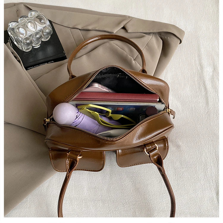 Accessorize stylishly with this black shoulder bag for women. This versatile handbag can be carried as a purse or a crossbody bag, making it a chic and practical choice for all occasions. -