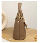 Upgrade your accessories with this new bucket bag for women. Featuring a fashionable and versatile design, this handheld bag is perfect for adding a chic and trendy touch to your look. -