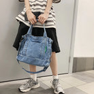 Elevate your casual look with this denim shoulder bag for women. Featuring a large design and zipper closure, this bag is perfect for shopping and everyday use, adding a touch of style to your outfit. -