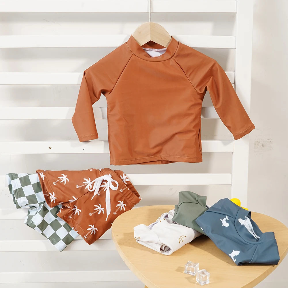 Make a splash in style with this fashionable and cute long-sleeve swimsuit for baby boys and girls—perfect for pool days and swim fun! -